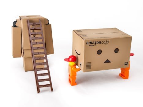 amazon Unique cardboard box figures interacting with a ladder on a white background, showcasing creativity and playfulness.